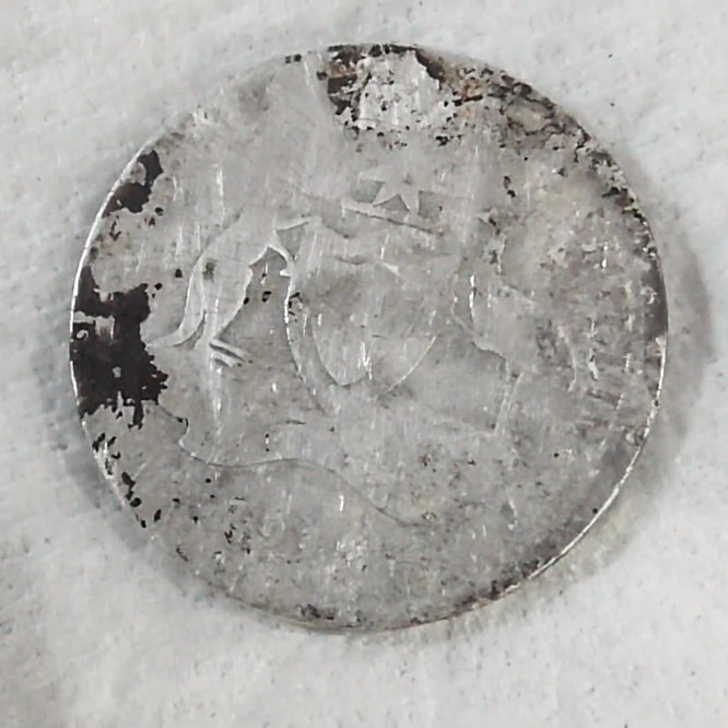 obverse side of coin in final round of the ultrasonic coin cleaning process