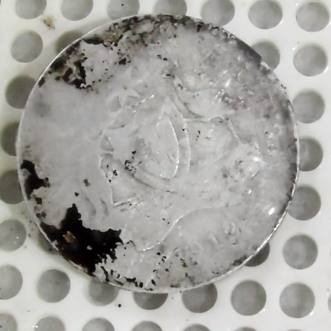 The Better Side (Obverse) of the coin in round one of the ultrasonic coin cleaning process